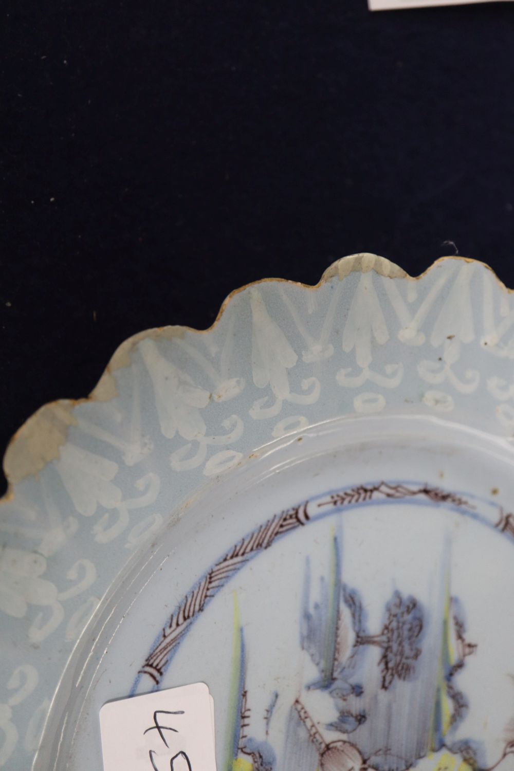 A Bristol Delft petal rimmed dish with Bianco Sopra Bianco border, diameter 22cm, cracked